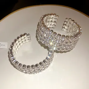 Macro view of brilliant rhinestone pavé detailing on metallic open cuff bracelet