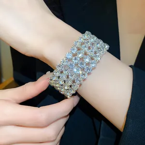 Detailed view of a wide silver-tone bracelet with multiple rows of sparkling rhinestones