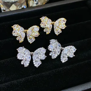 Close-up of elegant silver needle zircon butterfly stud earrings in gold and silver