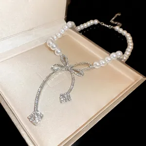 French style baroque pearl necklace with sparkling diamond-encrusted bow pendant