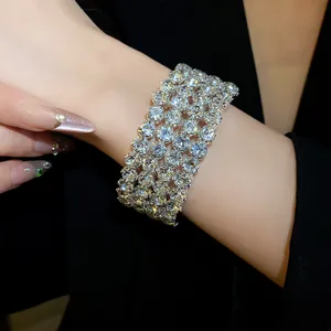 Detailed close-up showing the fire and sparkle of a four-row rhinestone cuff bracelet.