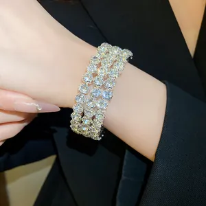 Detailed view of a stunning luxurious triple-row rhinestone bracelet worn on a wrist