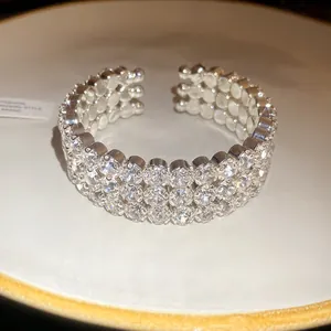 Macro detail of high-shine three-row rhinestone-encrusted metal open cuff bracelet