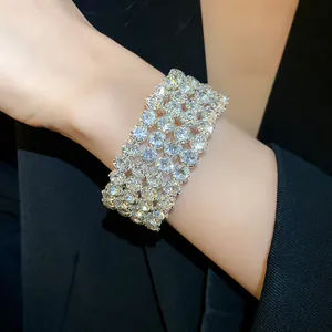 Detailed view of a luxurious four-row brilliant rhinestone cuff bracelet worn on a wrist