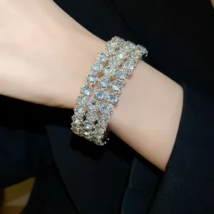 Elegant close-up view of a three-row rhinestone-encrusted silver metal bangle on a wrist