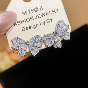 Close-up detail of S925 silver butterfly earrings with sparkling cubic zirconia