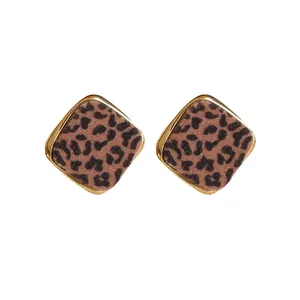 Elegant leopard print diamond-shaped stud earrings with a polished gold-plated metal border