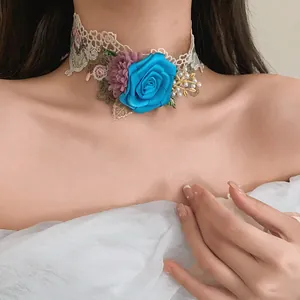 Close-up of elegant French style floral lace choker with blue rose and pearl accents on model