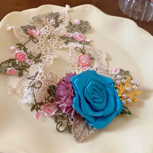 Close-up of elegant French pastoral lace choker with a large blue fabric rose and pearls