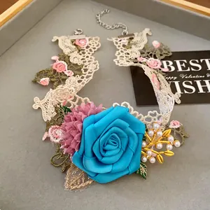 Detail of a French style floral choker necklace featuring a large blue rose and pearls
