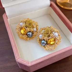 Vintage gold-plated flower stud earrings with pearls and amber crystals in a pink velvet box