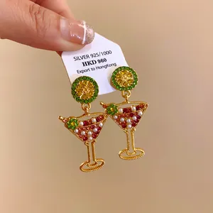 Detailed shot of cocktail glass earrings with rhinestones and lime slice design