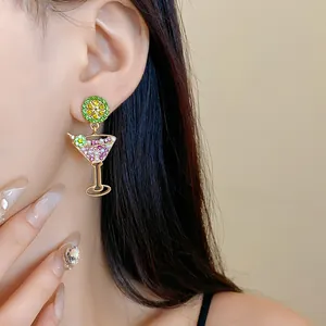 Detailed view of fashionable crystal lime and cocktail glass drop earrings with pearls