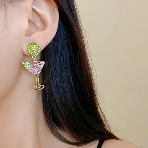 Close-up of rhinestone lime cocktail glass earring with pearls and colorful stones