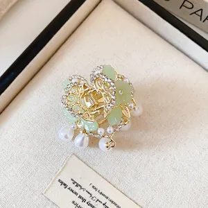 Antique style butterfly hair claw clip with elegant green accents and pearl tassels