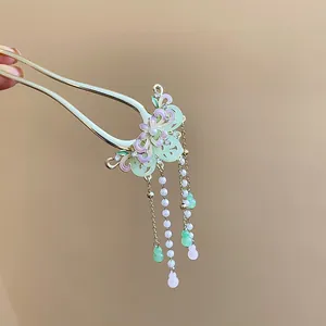Detailed view of an elegant traditional butterfly tassel hair stick with enamel finish