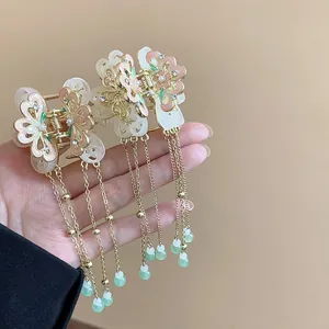 Detailed view of butterfly hair clips with elegant long tassels and enamel finish beads