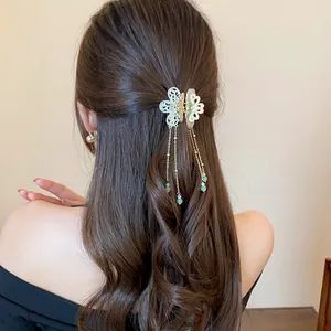 Elegant Chinese style butterfly hair claw clip with green beaded tassels on model's hair