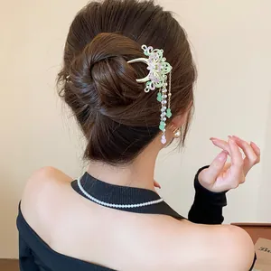 Elegant detail of a Chinese style butterfly tassel hair clip worn in a sophisticated bun