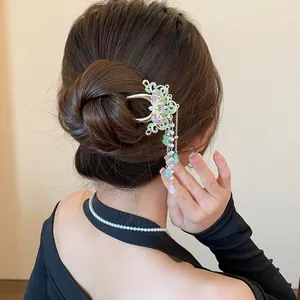 Detail view of a Chinese style butterfly hair clip with enamel finish and pearl tassels