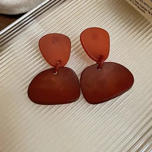 Detailed view of brown Maillard geometric resin drop earrings with matte finish
