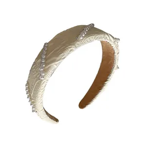 Elegant cream textured fabric headband with pearl embellishments for chic hair styling