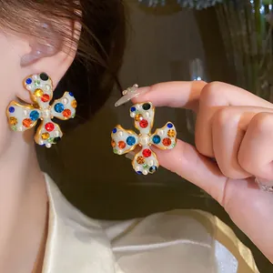 Detailed view of fashionable flower ear clips with colorful rhinestones and pearls