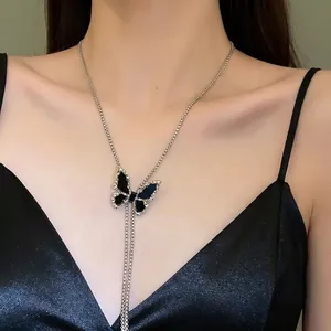 Elegant black butterfly pendant necklace featuring a silver chain and sparkling rhinestones