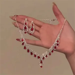 Close-up detail of vintage red waterdrop rhinestone necklace and matching earrings set