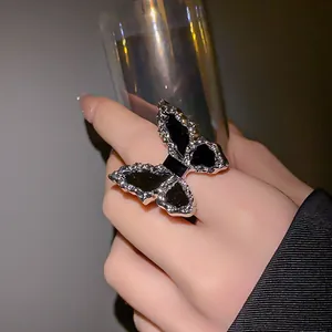 Silver butterfly ring with black enamel inlay and distressed metal finish