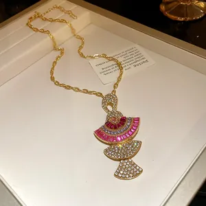 Close-up of vintage gold necklace with tiered fan pendant and colorful crystals