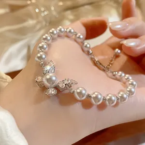 Elegant white pearl bracelet with a sparkling crystal butterfly charm in French vintage style.
