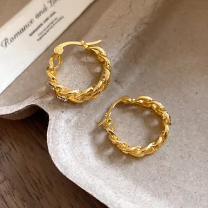 Detail view of vintage gold plated chain link hoop earrings with rhinestone accents.