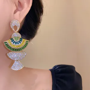 Close-up detail of vintage fan-shaped earrings with colorful crystal rhinestones