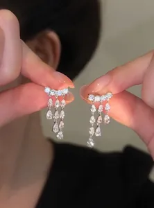 Close-up of 18k gold plated zircon water drop tassel earrings with sparkling detail