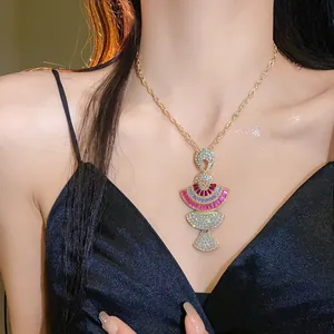 Elegant vintage fan-shaped pendant necklace with colorful crystals worn by a model