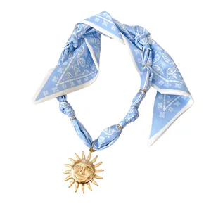 Vintage light blue paisley bandana choker necklace featuring a golden sun face pendant