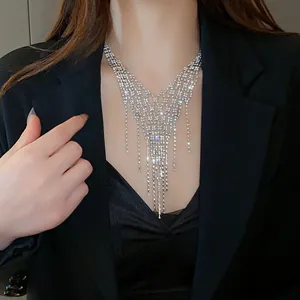 Close-up detail of a sparkling silver fringe necklace with rhinestones on a model