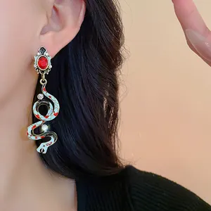 Vintage court style snake drop earrings with colorful enamel and rhinestones on model