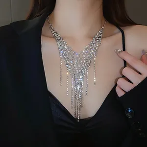 Detailed close-up of cascading silver rhinestone fringes on a geometric statement necklace