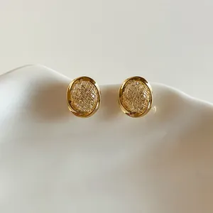 Elegant 18k gold plated circular stud earrings with minimalist textured design for women