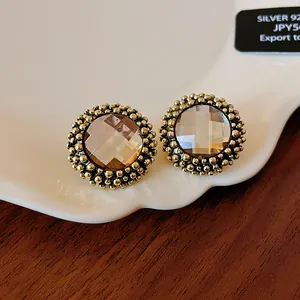 Vintage-style round flower stud earrings with faceted gemstone and beaded border