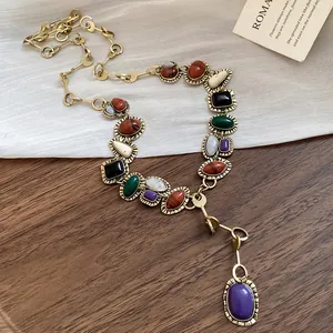 Vintage geometric resin necklace with multicolored stones on a gold chain detail