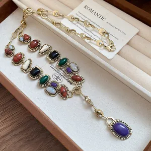 Close-up of vintage resin geometric necklace with colorful stones on jewelry tray