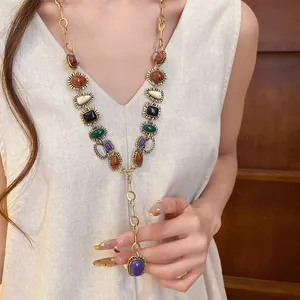 Detailed view of a vintage gold-toned necklace with colorful geometric resin stones.