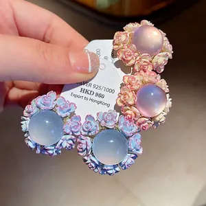 Elegant floral resin stud earrings with silver needles in sweet pink and blue colors.
