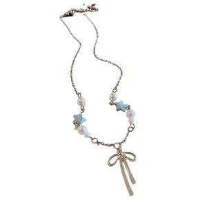 Elegant silver chain necklace with pearl accents, blue stars, and a bow pendant.