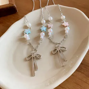 Detailed close-up of a sweet bow pendant necklace featuring pearls and colorful star beads