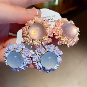 Close-up detail of elegant resin flower stud earrings featuring S925 silver needles