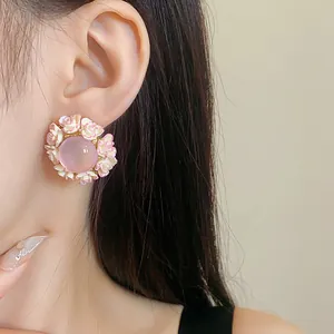 Close-up of elegant pink resin flower earrings worn by a model for a sweet style.